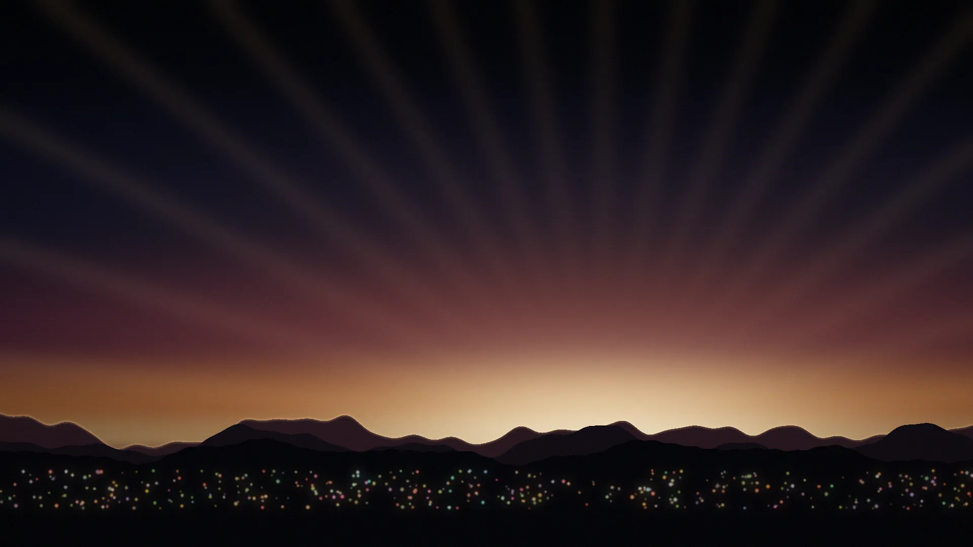 A warm sunrise over mountains with rays of light